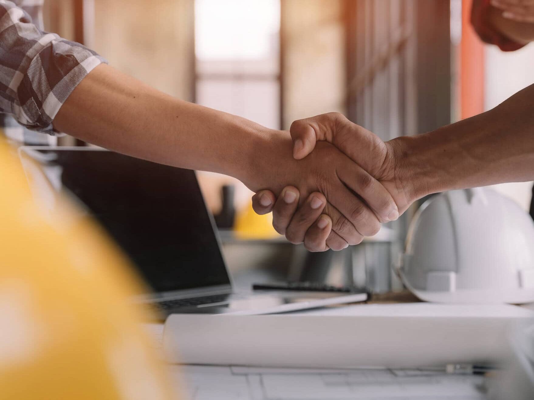 architects and engineers shake hands while working for teamwork and cooperation after completing an agreement in an office facility, successful cooperation concept.